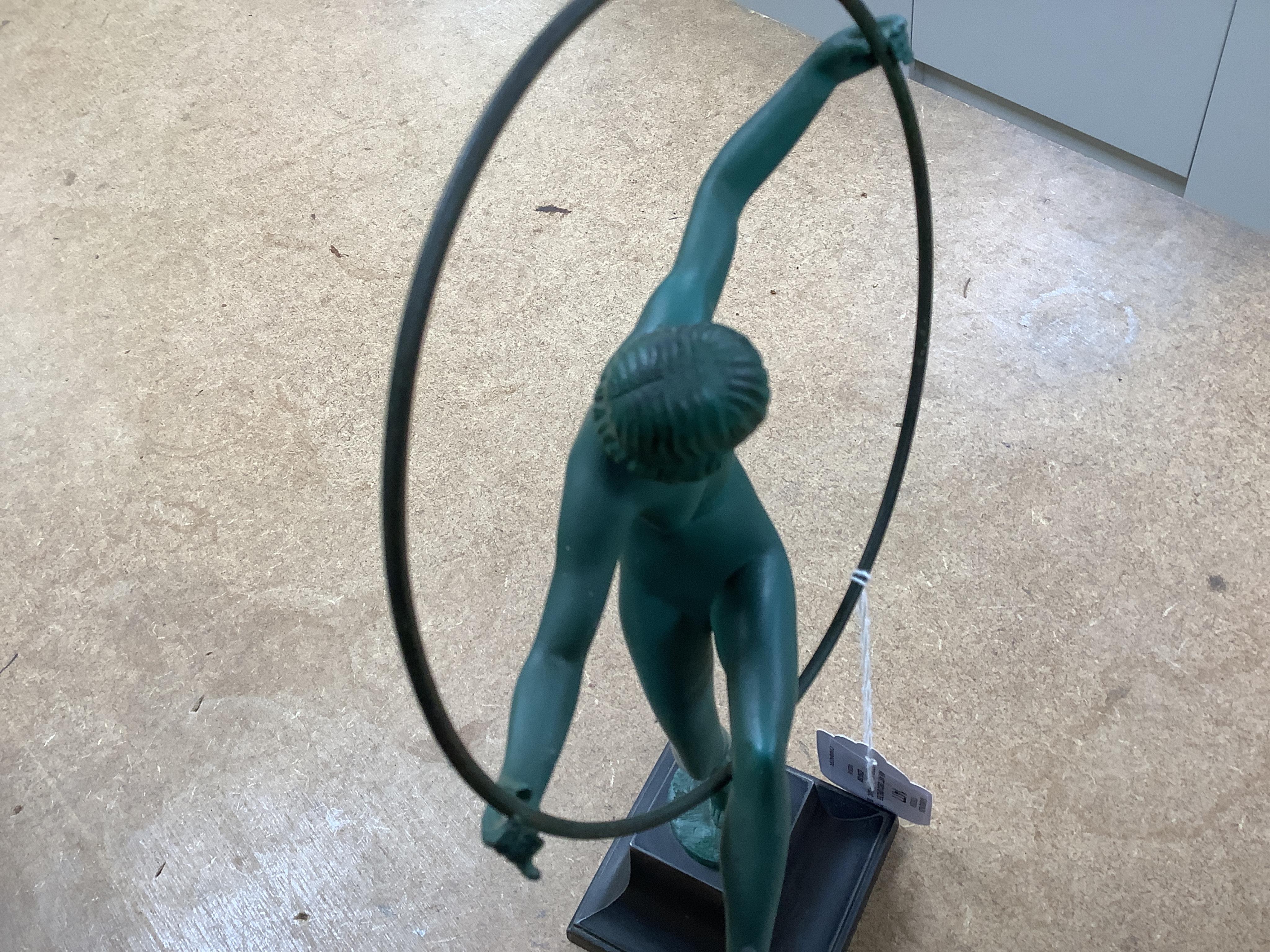 An Art Deco spelter model of a hoop dancer, signed Briand, 29cm. Condition - fair to good